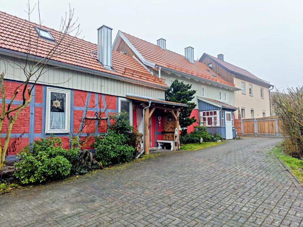 a row of houses with red and blue paint at Ferienhaus vom Bahratal in Hausen