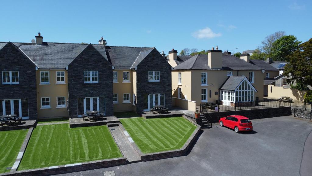 a house with a red car parked in a driveway at Number 3 Bank House in Schull