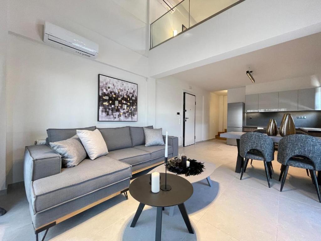 a living room with a couch and a table at Athenean Gem Near Metro Mall in Athens