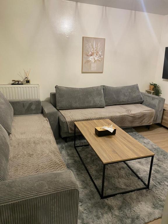 a living room with a couch and a coffee table at Chambre privée Sdb kitchenette proche de Paris in Saint-Ouen