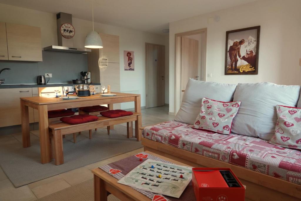 a living room with a couch and a table at Gîte La Grange in Chapelle