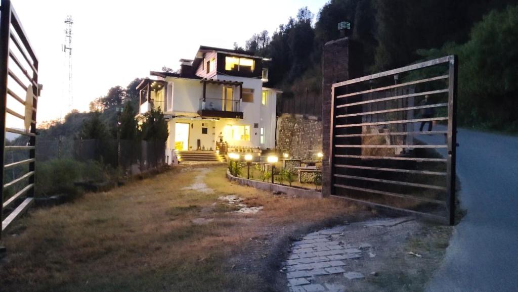 a building with a gate in front of a house at Luxury Chalet Villa in Shimla