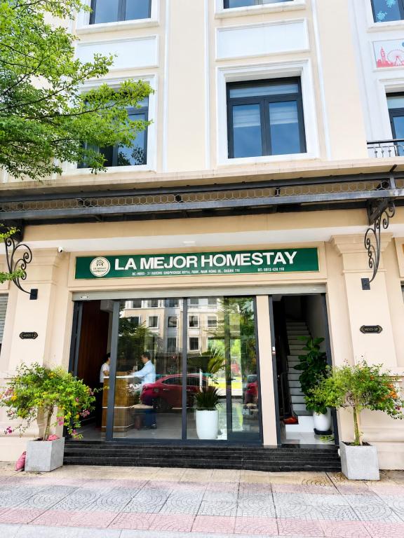 a store front of a building with a sign at La Mejor Homestay in Quang Tri