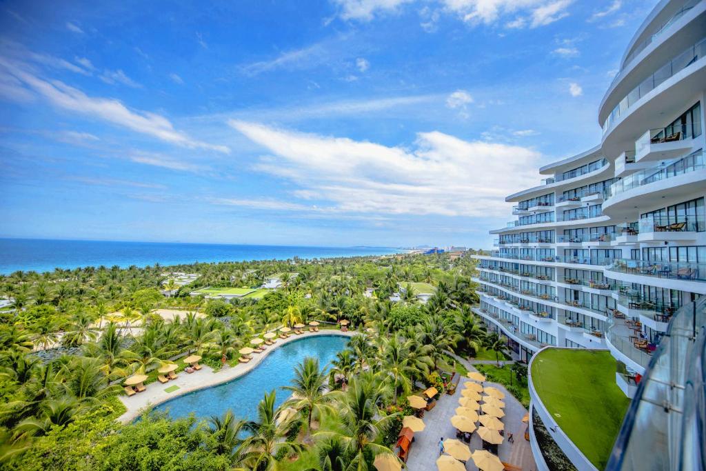 an aerial view of a resort with a pool and palm trees at Cam Ranh Riviera Beach Resort & Spa in Nha Trang