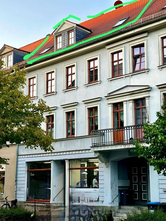 a large white building with a red roof at Fewo Charlotte in Weimar