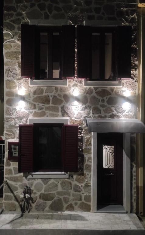 a stone building with a television and a fireplace at Pierres Blanches Center in Mytilene
