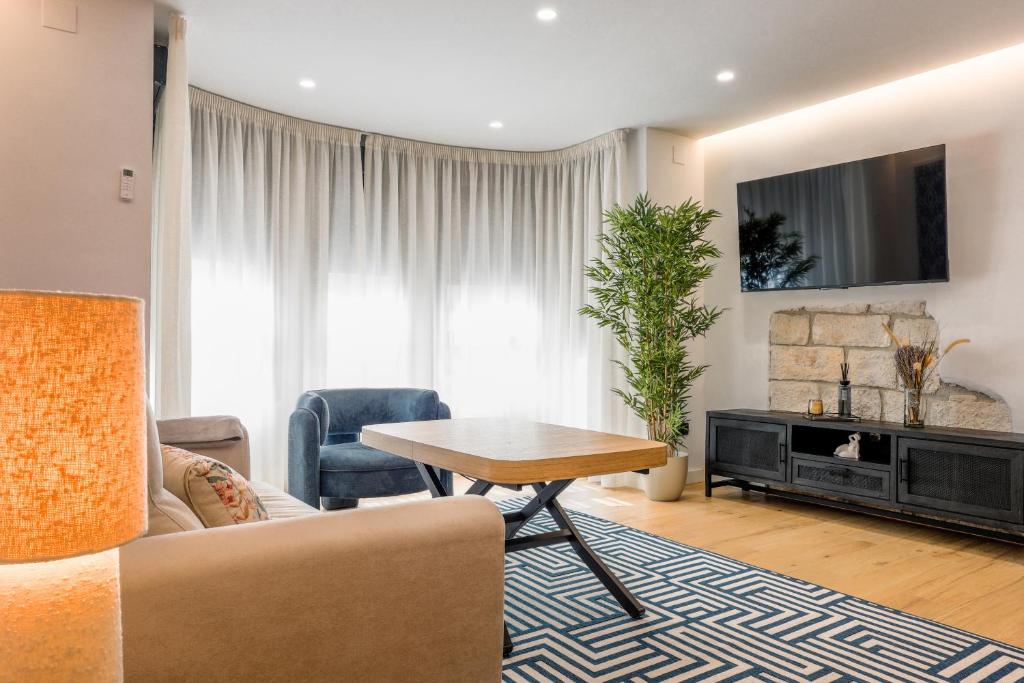 a living room with a couch and a table at Apartamentos Don Tomás in Jaén