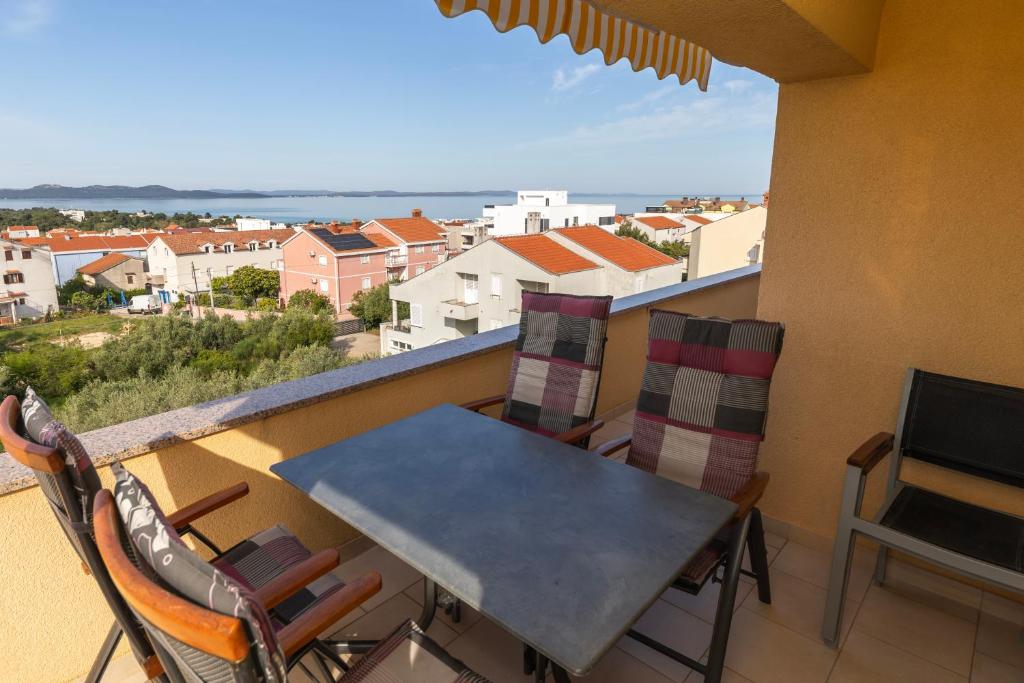 a balcony with a table and chairs and a view at Villa Zubčić in Zadar