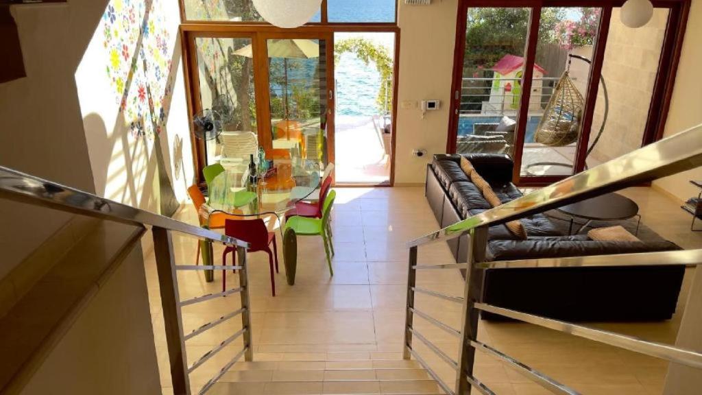 a living room with a glass table and a couch at Vila Nadja SEAFRONT in Bar