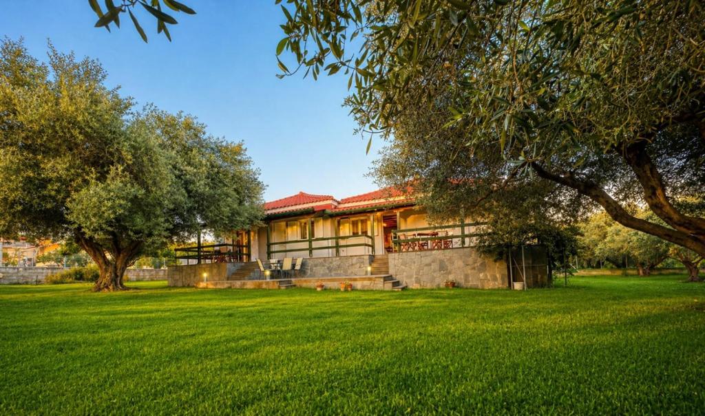 a building in a park with green grass and trees at Emerald Cove in Kanali