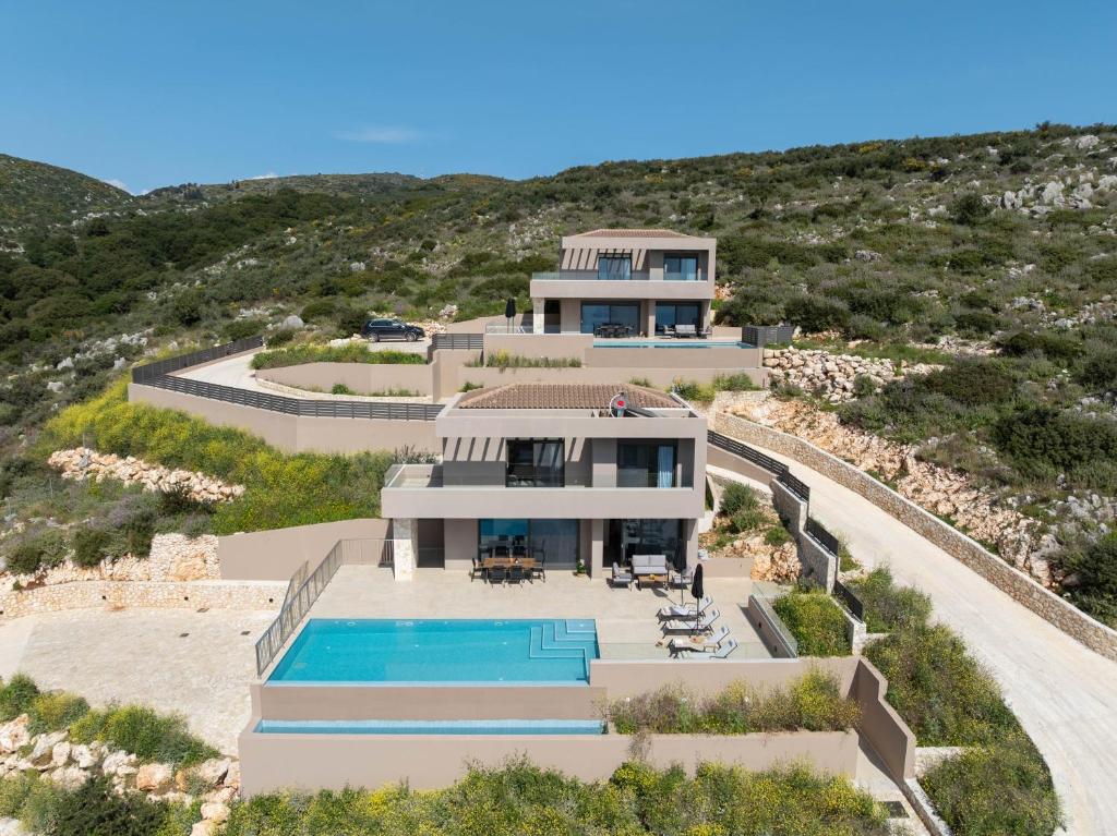 an aerial view of a house with a swimming pool at Lina's Luxury Villas in Skala