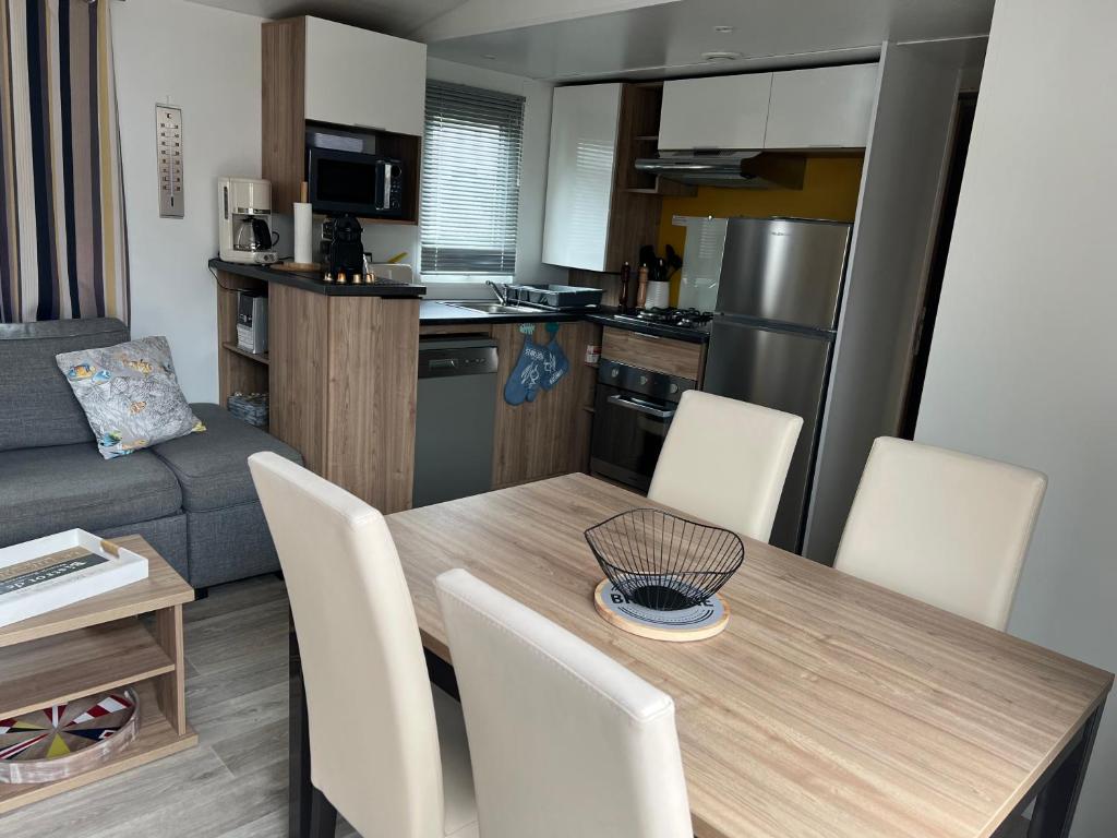 a kitchen and dining room with a table and chairs at Mobil home 459 in Pont-Aven