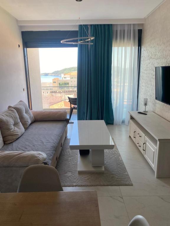 a living room with a couch and a table at Elia in Bečići