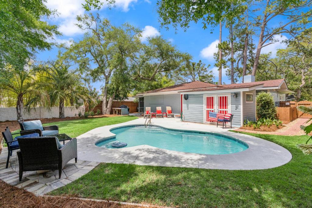 a backyard with a swimming pool and a house at Sea Renity - 4333 Twelfth Street in Saint Simons Island