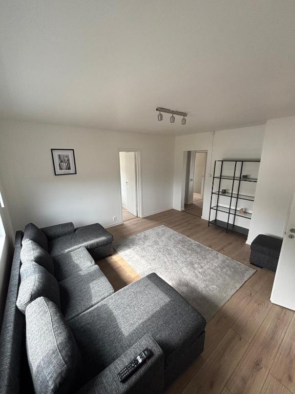 a living room with a black couch and a living room with at High Coast Stay Floor 2 in Ramvik