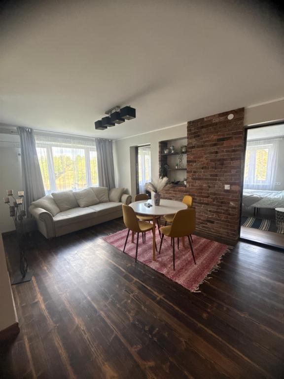 a living room with a table and a couch at Hubane korter järve kaldal in Värska
