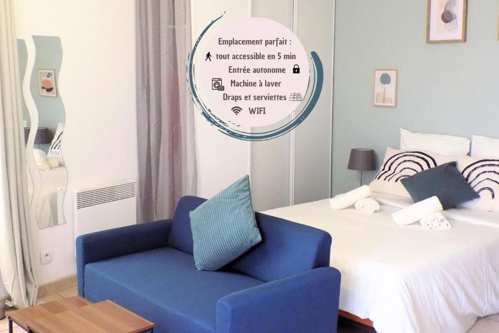 a bedroom with a bed and a blue chair at Studio Revy 1 - Centre ville in Néris-les-Bains