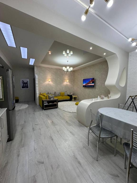 a large living room with a large bed and a table at Zarisha Home in Fergana
