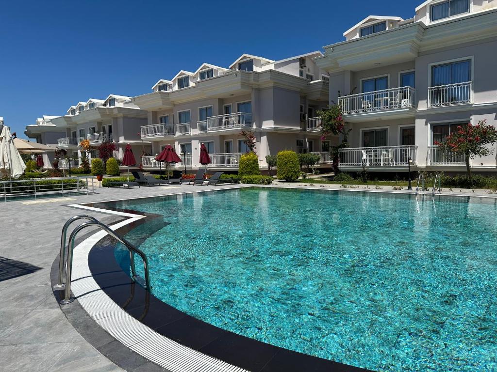 a large swimming pool in front of a building at Defne Beach Makri in Fethiye
