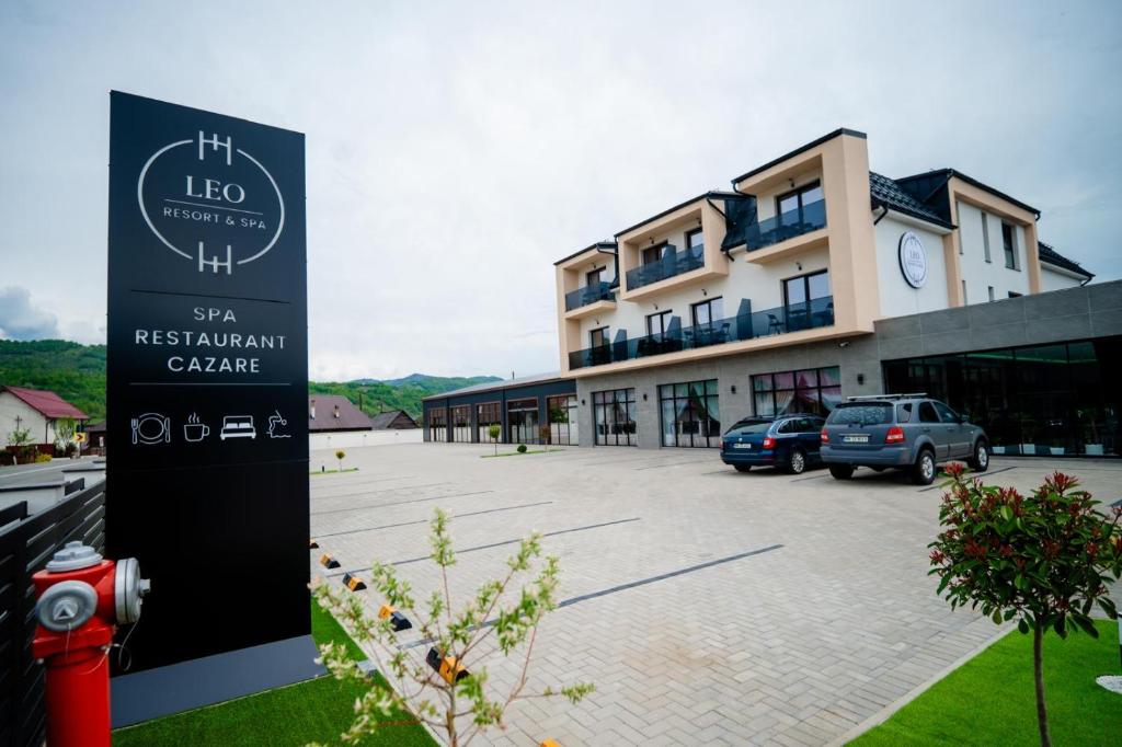 a building with a sign in front of a parking lot at Leo Resort and Spa in Petrova