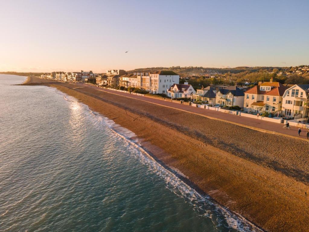 an aerial view of a beach with houses and condos at The Beach Escapes in Hythe