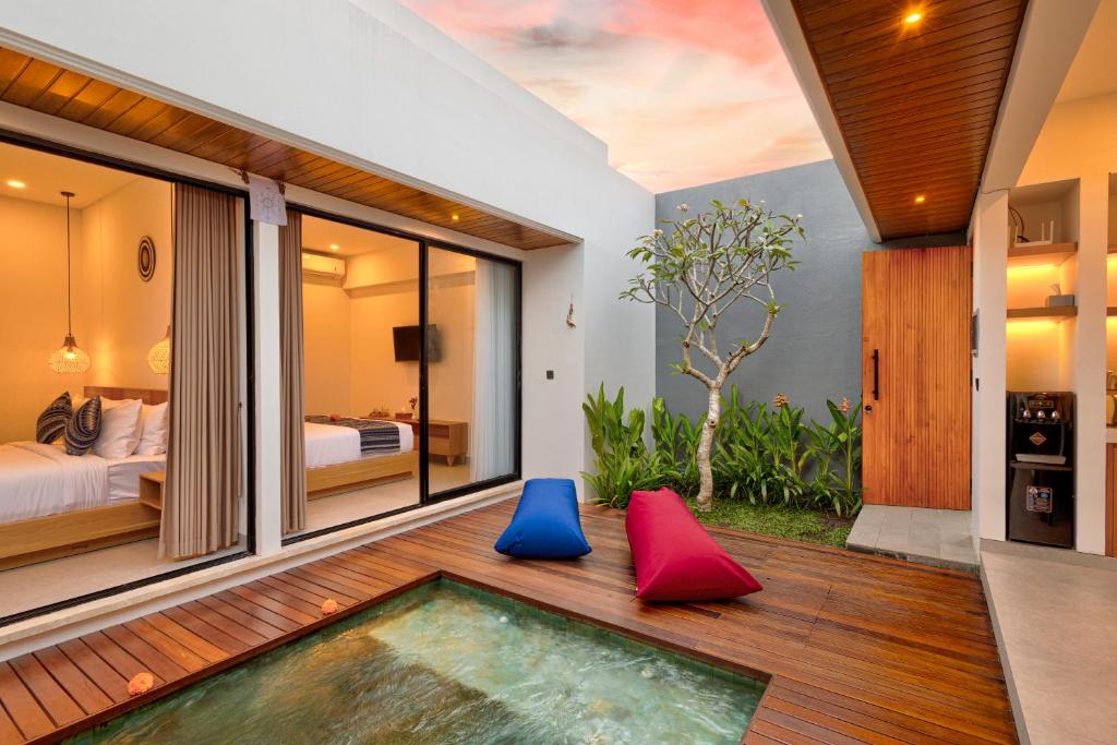 a room with a swimming pool and a bedroom at Tapan Harmony Villa Ubud in Ubud