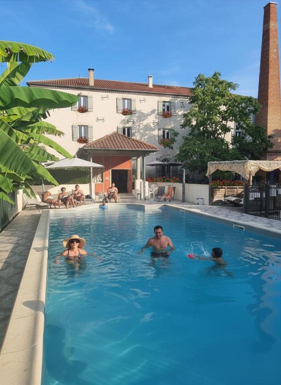 a group of people swimming in a swimming pool at Moulin de Saint Laurent in Saint-Laurent