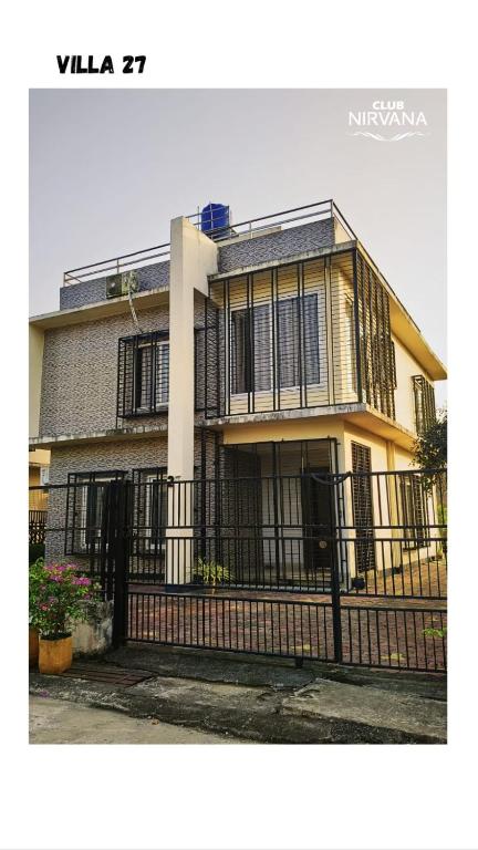 a house with a black fence in front of it at Villa 27 in Sonāpur