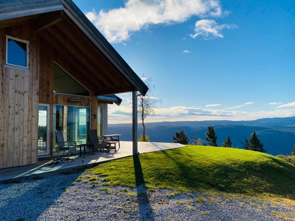 a cabin on a hill with a view of the mountains at Large cabin with panoramic wiews in Ål, Hallingdal in Al
