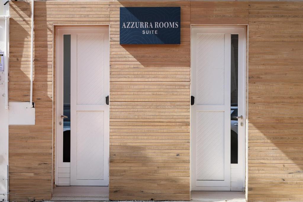 three doors on a building with a sign on it at Azzurra Rooms Suite in Battipaglia