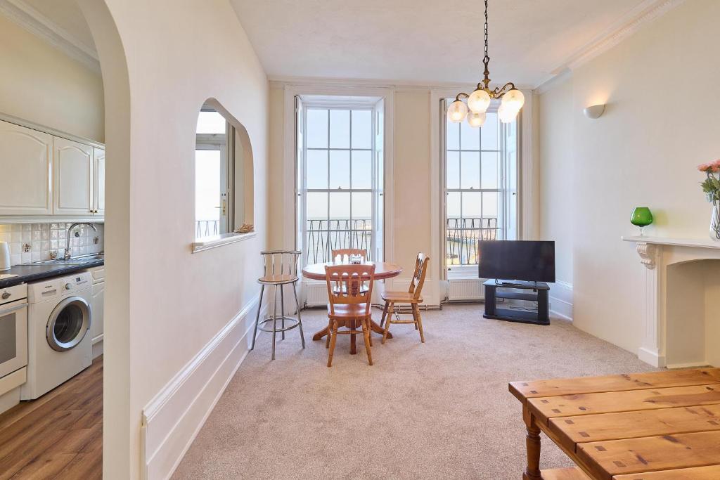 a kitchen and dining room with a table and chairs at Coastal charm in Herne Bay