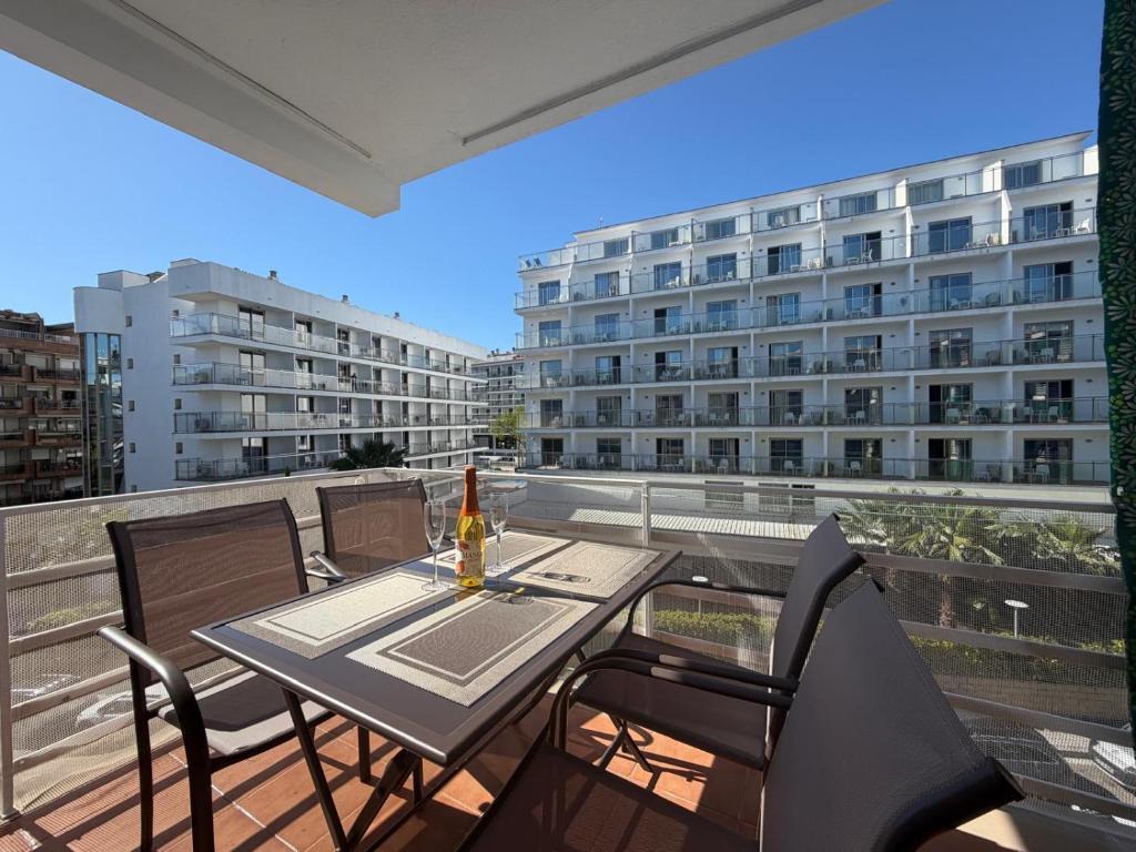 a table and chairs on a balcony with a building at Tropical Salou in Salou