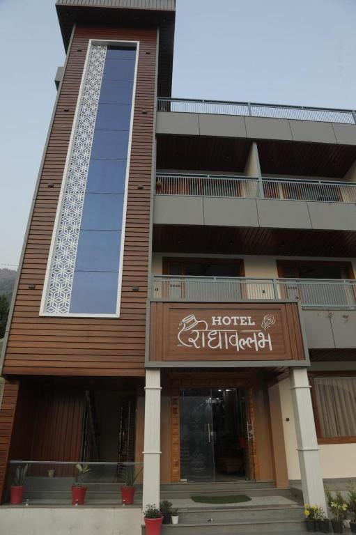 a hotel with a sign on the front of a building at Hotel Radha Vallabh in Ukhimath