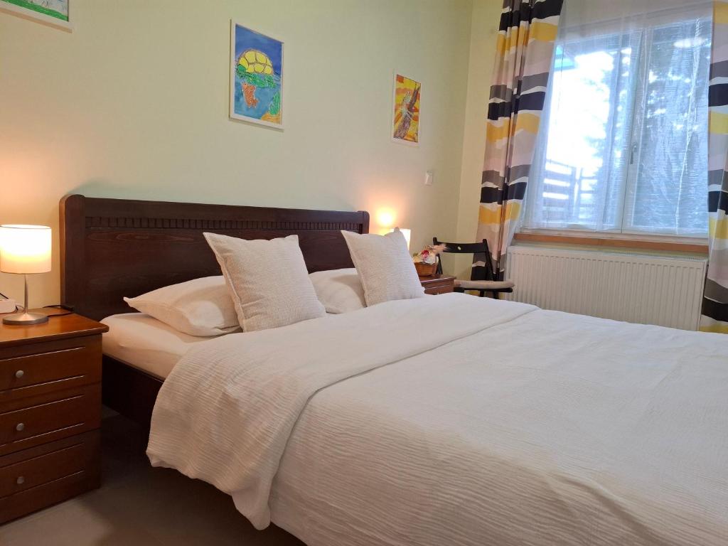 a bedroom with a large bed with white sheets and pillows at Elato apartment in Florina