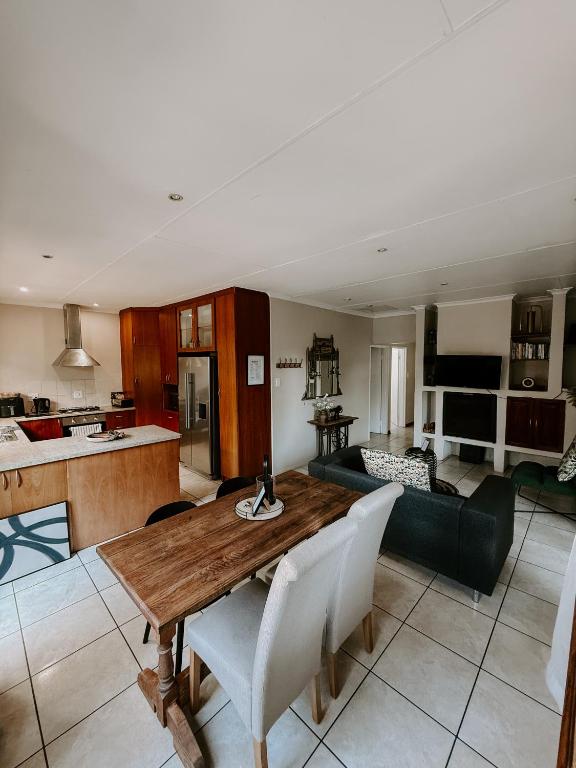 a living room with a table and a couch at The Garden Den in Nelspruit