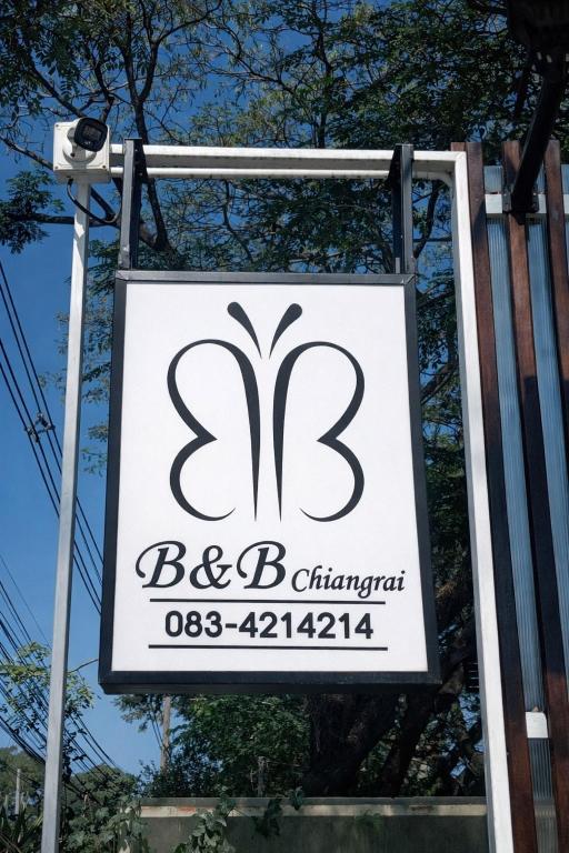 a sign for a building with the number at B&B Chiangrai in Chiang Rai