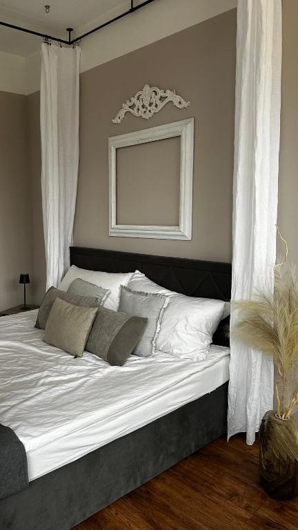 a bedroom with a large white bed with curtains at Ro42om Schönewerd in Schönenwerd
