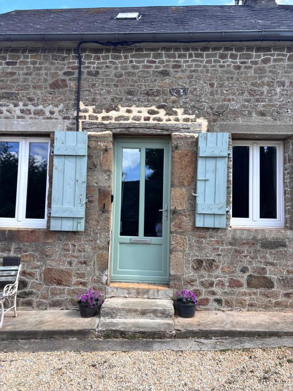 a brick house with a green door and two windows at La Ramée - 2 bedroom - Wi-Fi - Garden - Parking in Saint-Siméon