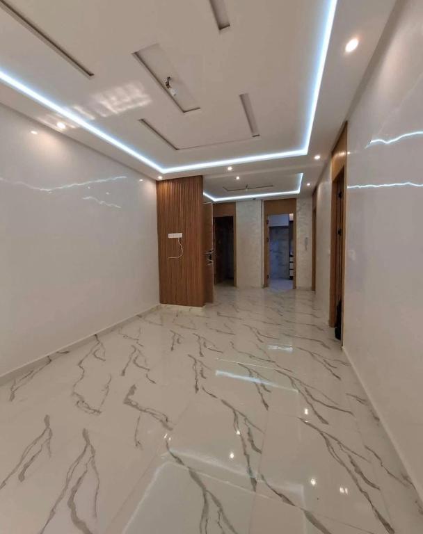 a hallway with a marble floor in a building at Benslimane in Ben Slimane
