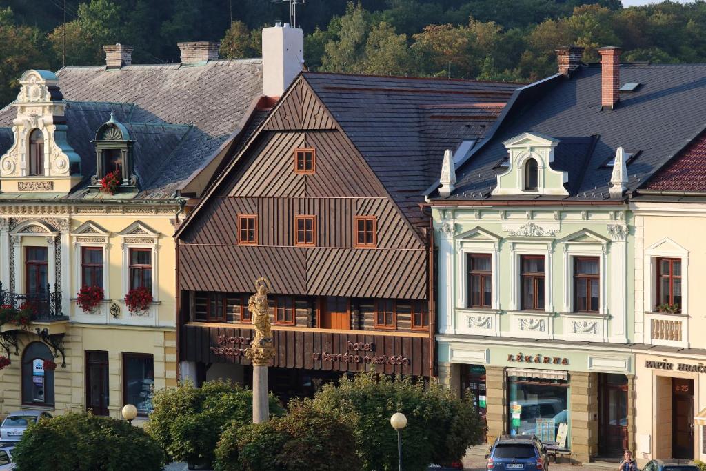 a group of buildings on a street in a town at U Černého medvěda in Jablonné nad Orlicí