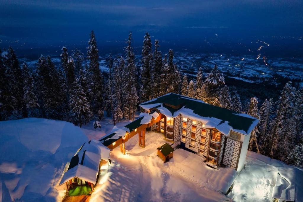 a building covered in snow at night at Hotel Royal Castle in Gulmarg