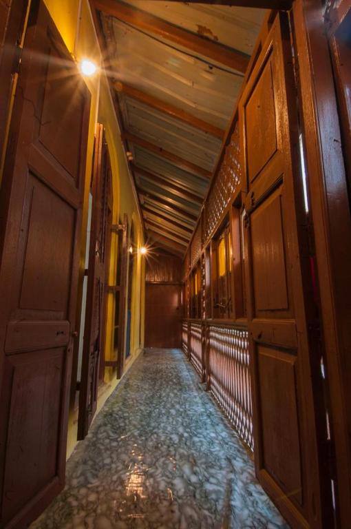 an empty hallway in an old building with a hallway at MAKAPUS Stone Town Apartments in Zanzibar City