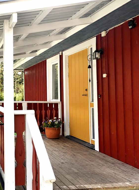 a front porch of a house with a yellow and red door at Lysviks guesthouse inclusief extra service in Lysvik