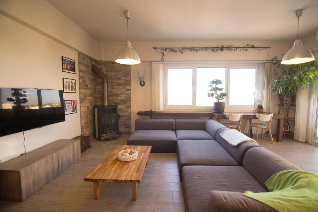 a living room with a couch and a table at Vas' Penthouse in Nicosia