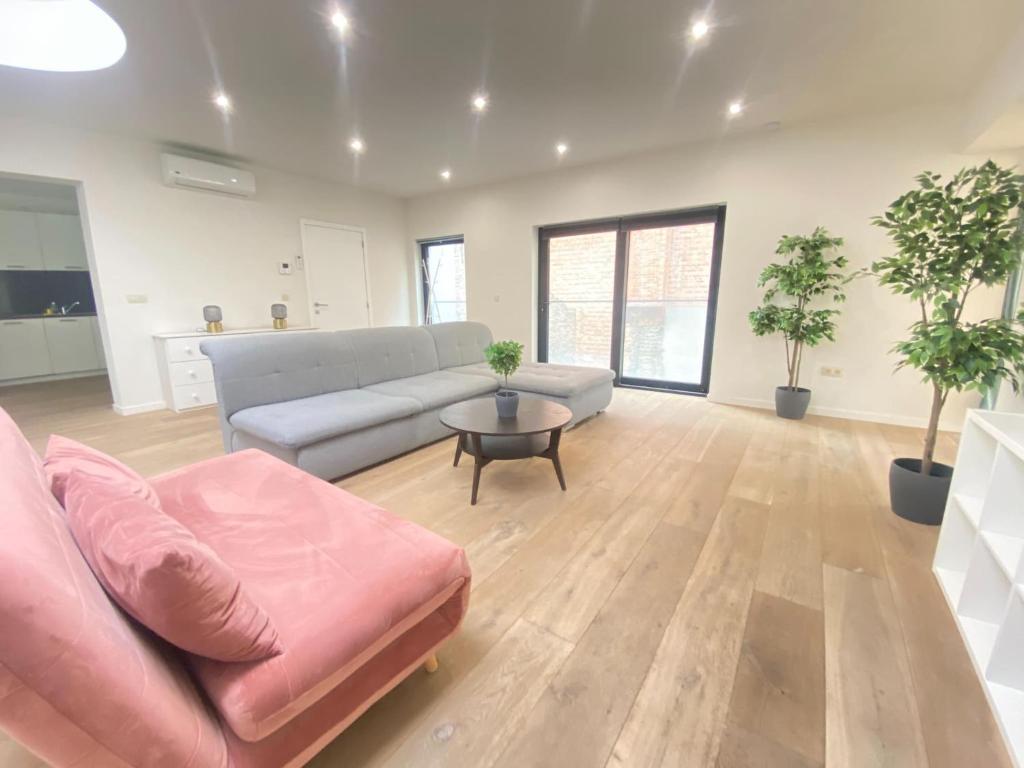 a living room with a couch and a table at 12-Guest Apartment on the Main Square in Antwerp
