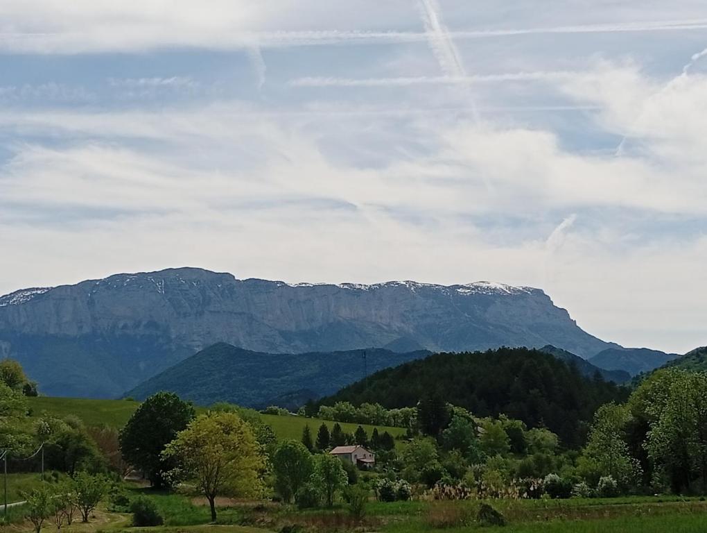 a view of mountains and a house in a field at Charme - Centre historique de Die in Die