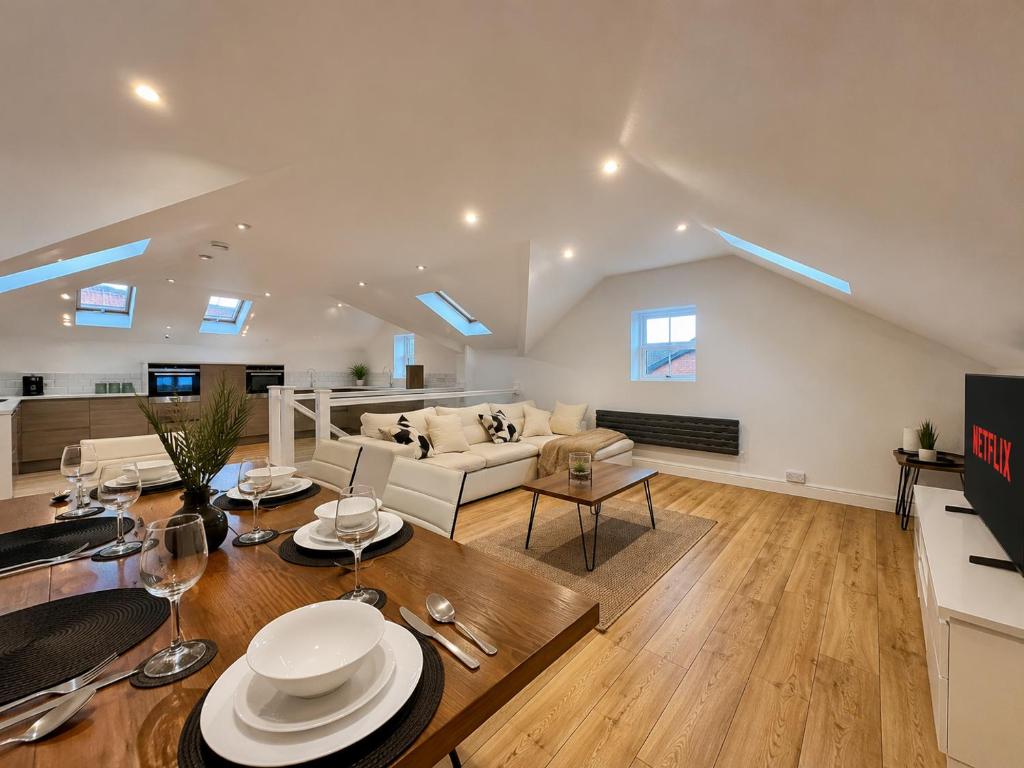 a living room with a couch and a table at Central duplex Apt in Leamington Spa in Leamington Spa