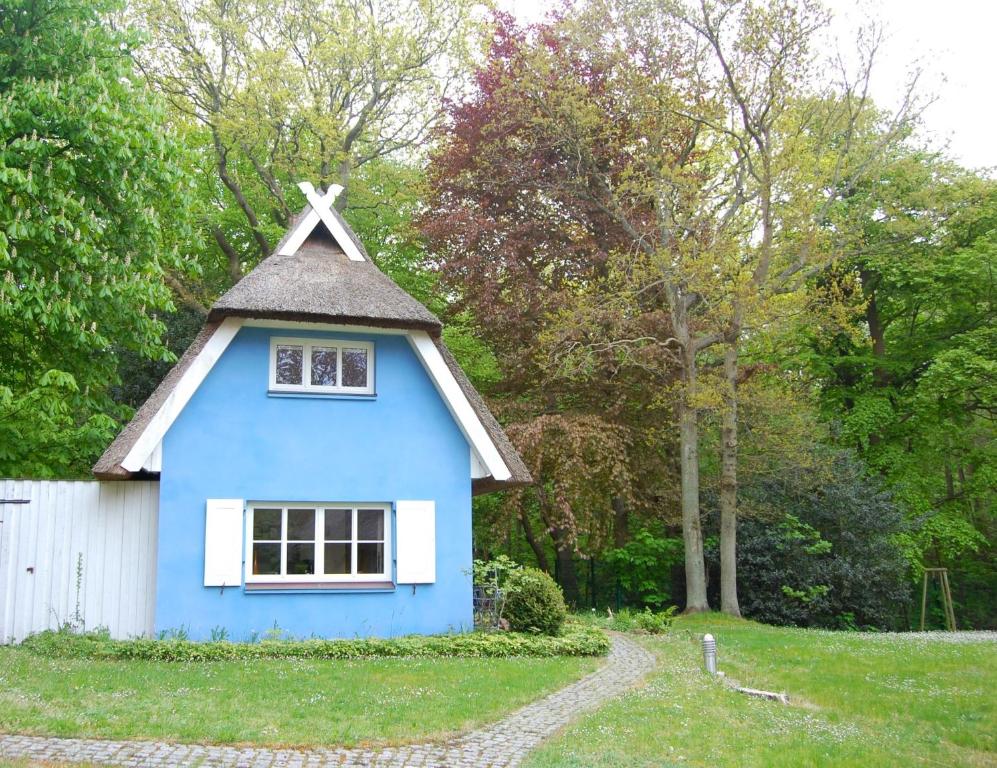 a blue house with a cross on top of it at Puppenhaus in Ahrenshoop