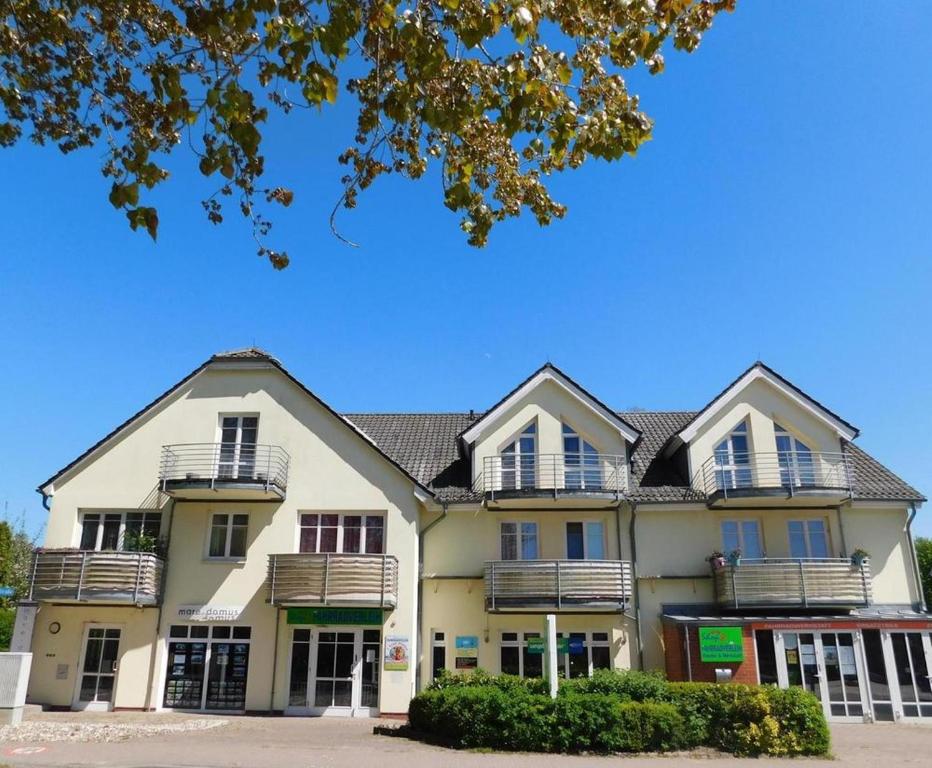 a large white building with balconies on it at Hummer in Althagen