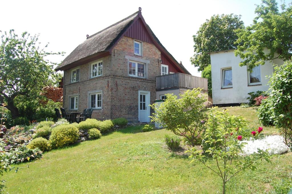 an old brick house with a garden in front of it at Altes Backhaus 2 in Althagen
